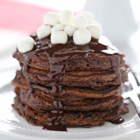 Hot Chocolate Pancakes feature rich chocolate buttermilk pancakes with a thick chocolate fudge topping and garnish with mini marshmallows || Hot Chocolate Pancakes via Handle the Heat || Christmas Breakfast: 10 Pancakes Kids Will Love! || Letters from Santa Holiday Blog