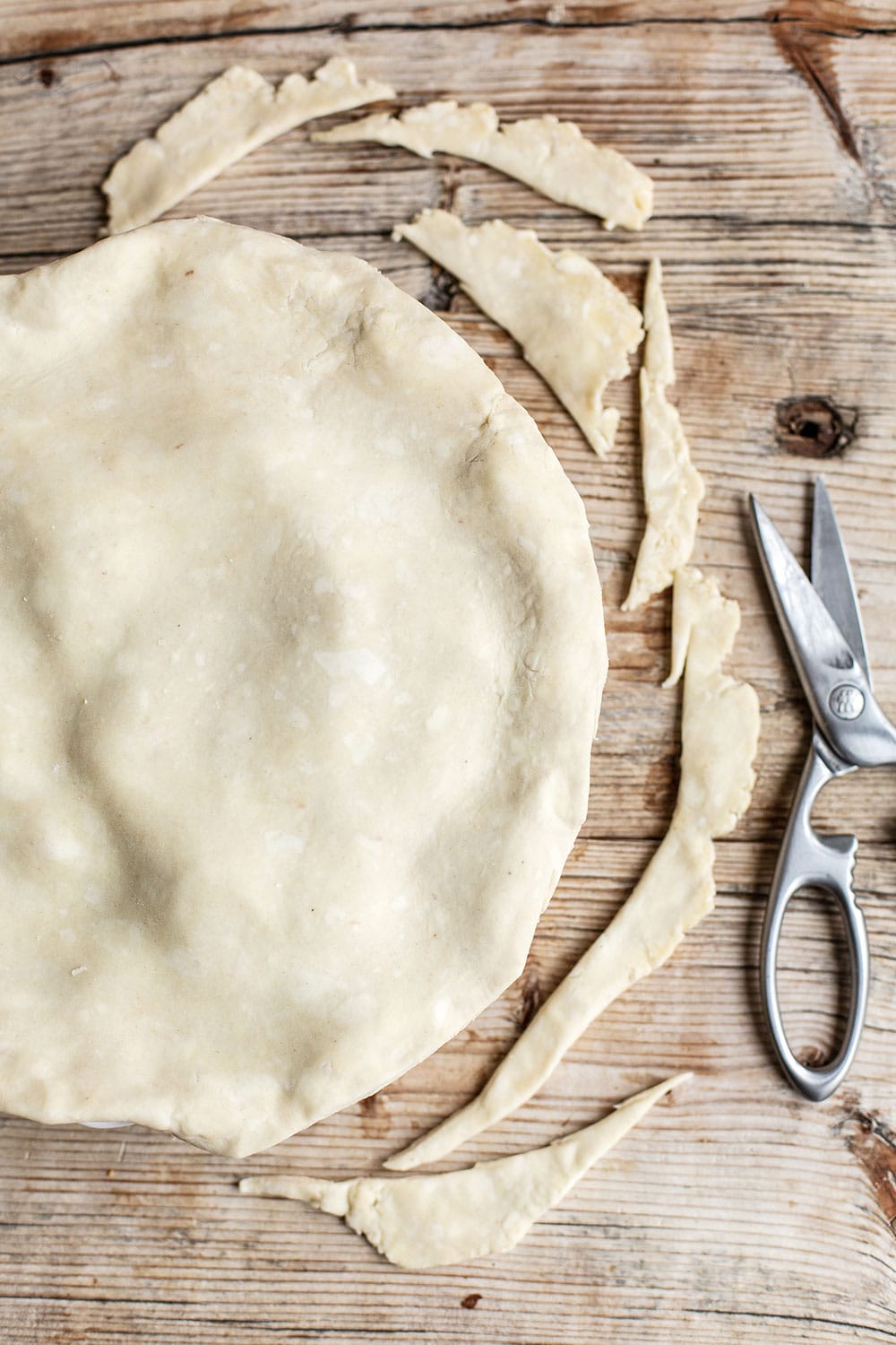 All butter pie dough being assembled into a double crust for apple pie