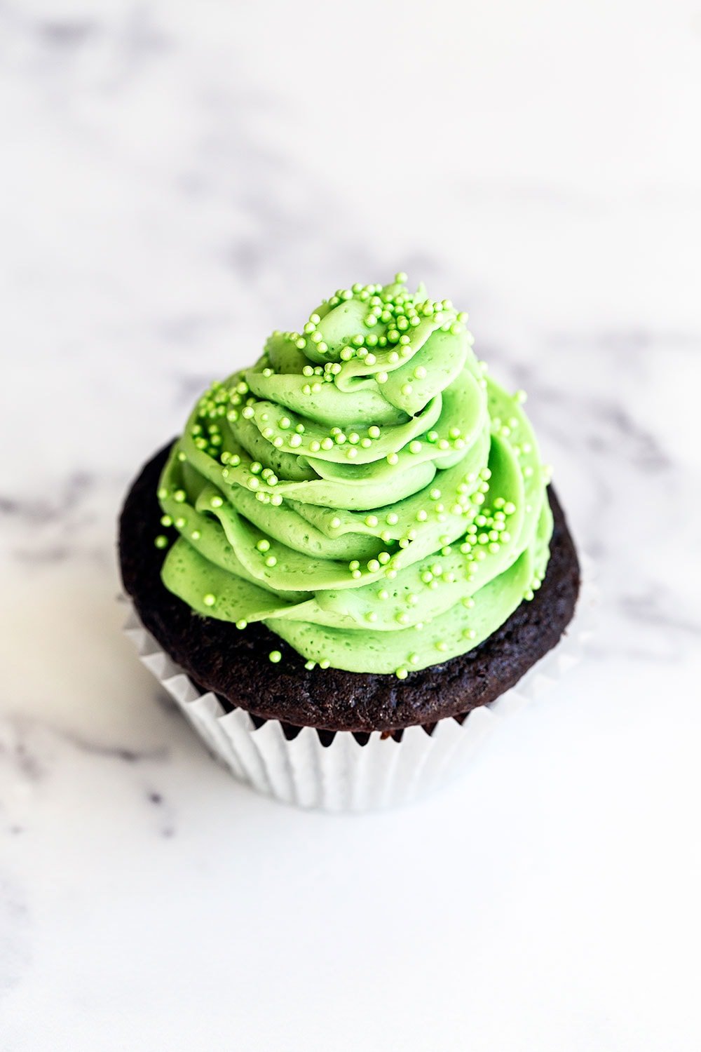 One chocolate mint cupcake on marble counter