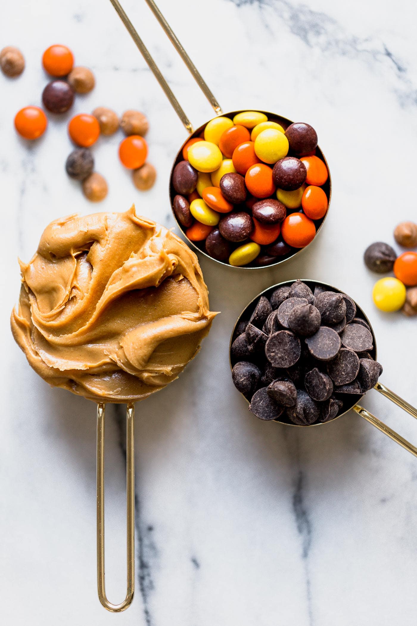 The makings of a delicious cookie: peanut butter, Reese's pieces, and chocolate chips!