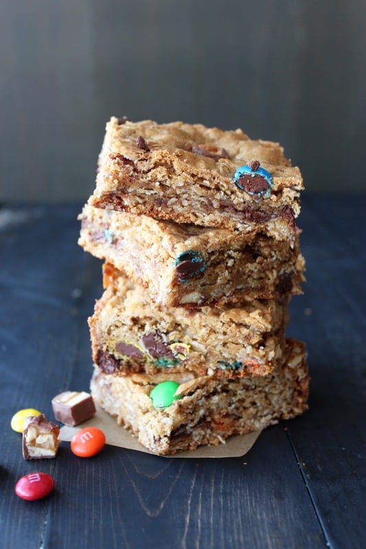 Monster Cookie Bars are filled with oatmeal, peanut butter, chocolate chips, and leftover Halloween candy!