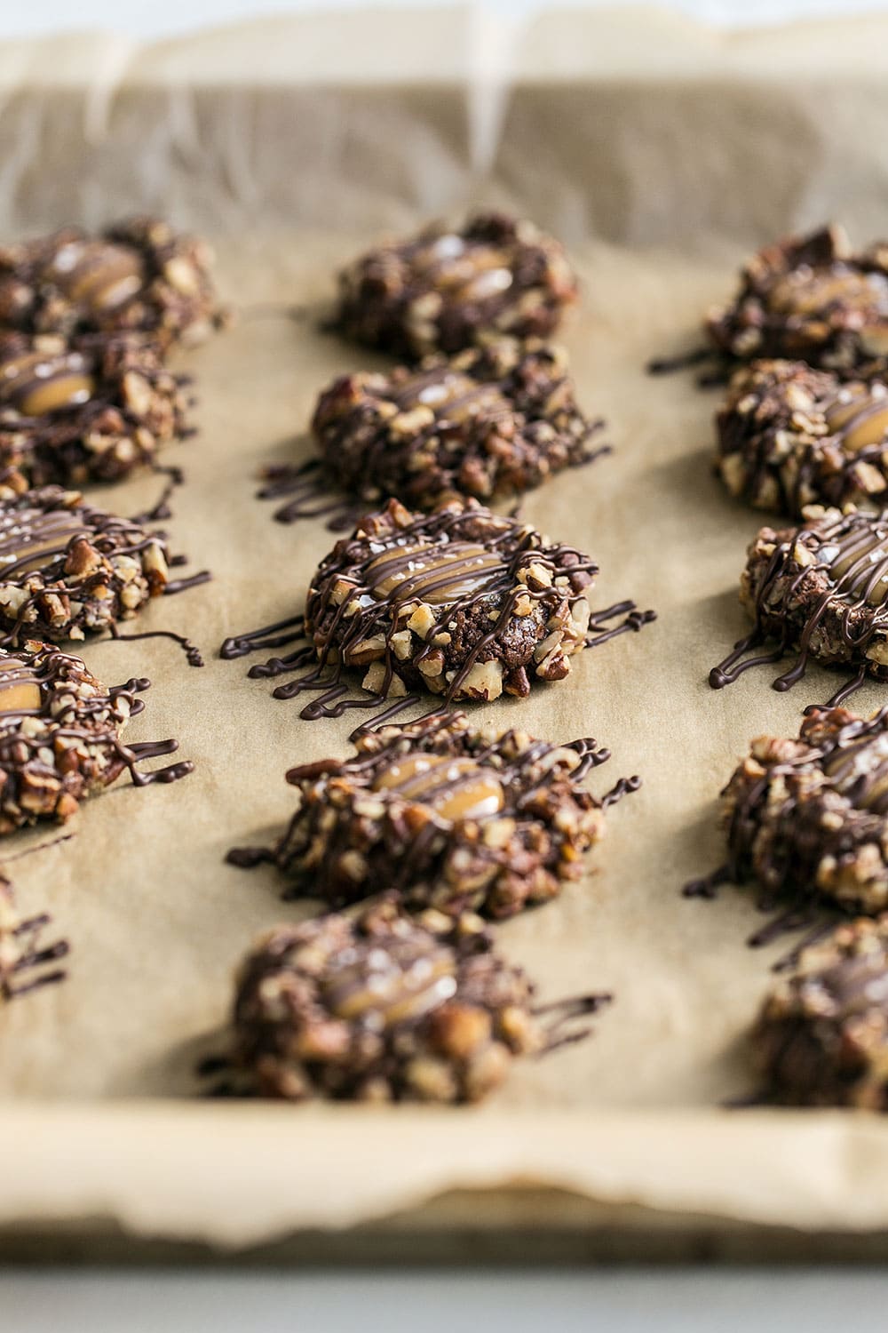 Chocolate, caramel, and pecan thumbprint cookies
