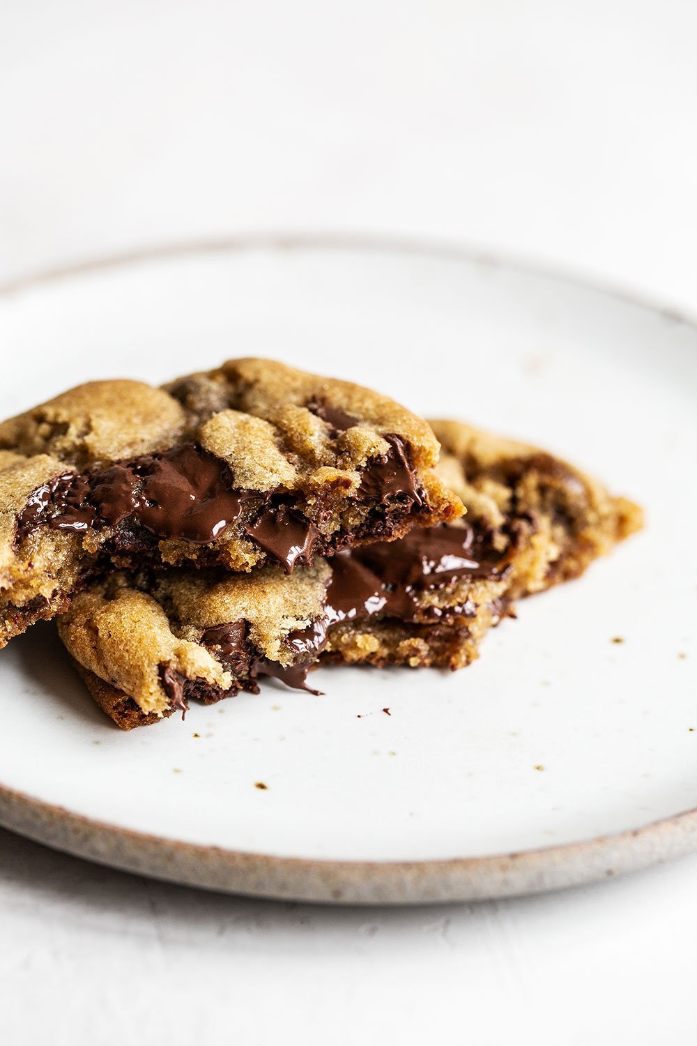 Chocolate chip cookie broken in half with gooey chocolate