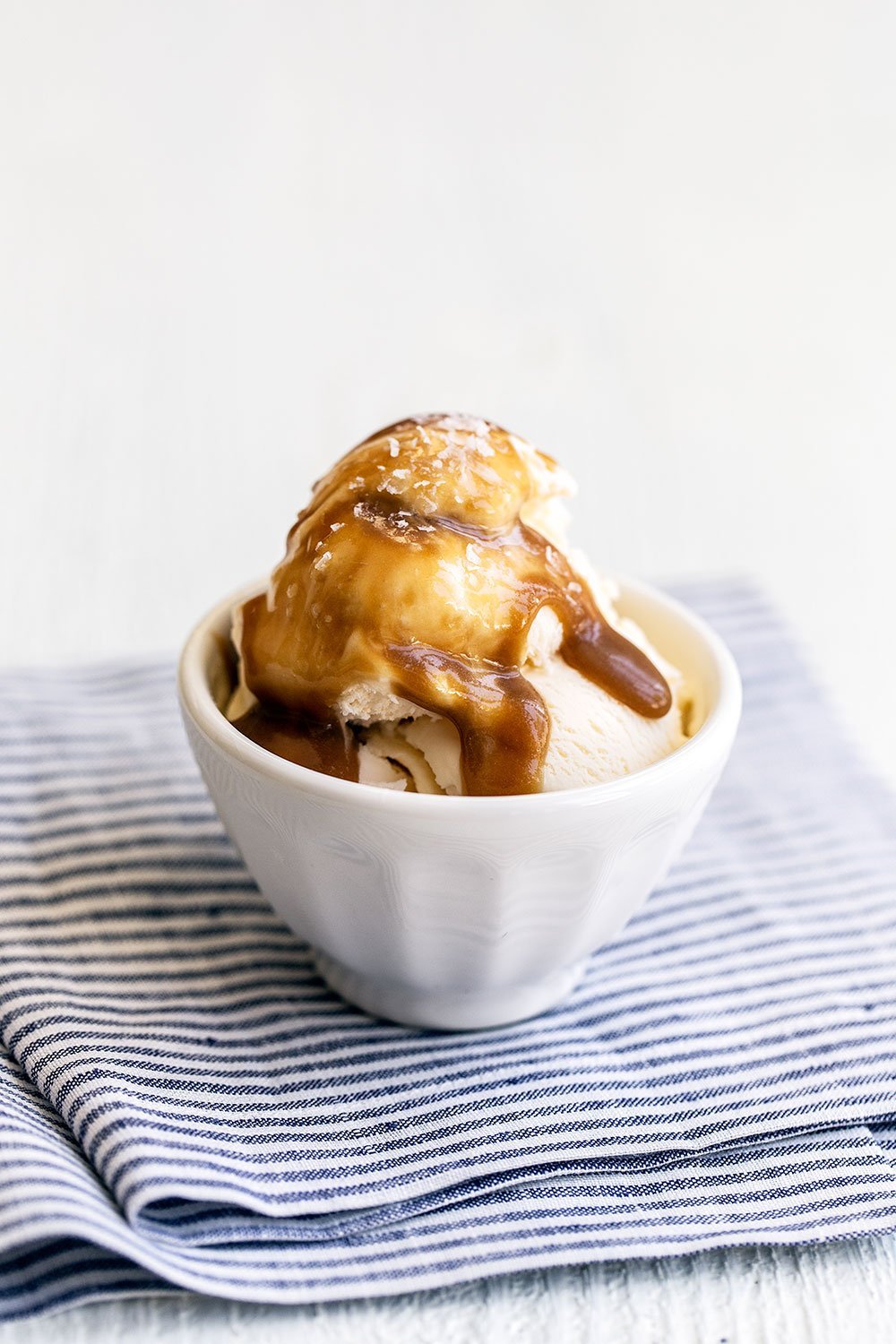 Butterscotch sauce poured over vanilla ice cream