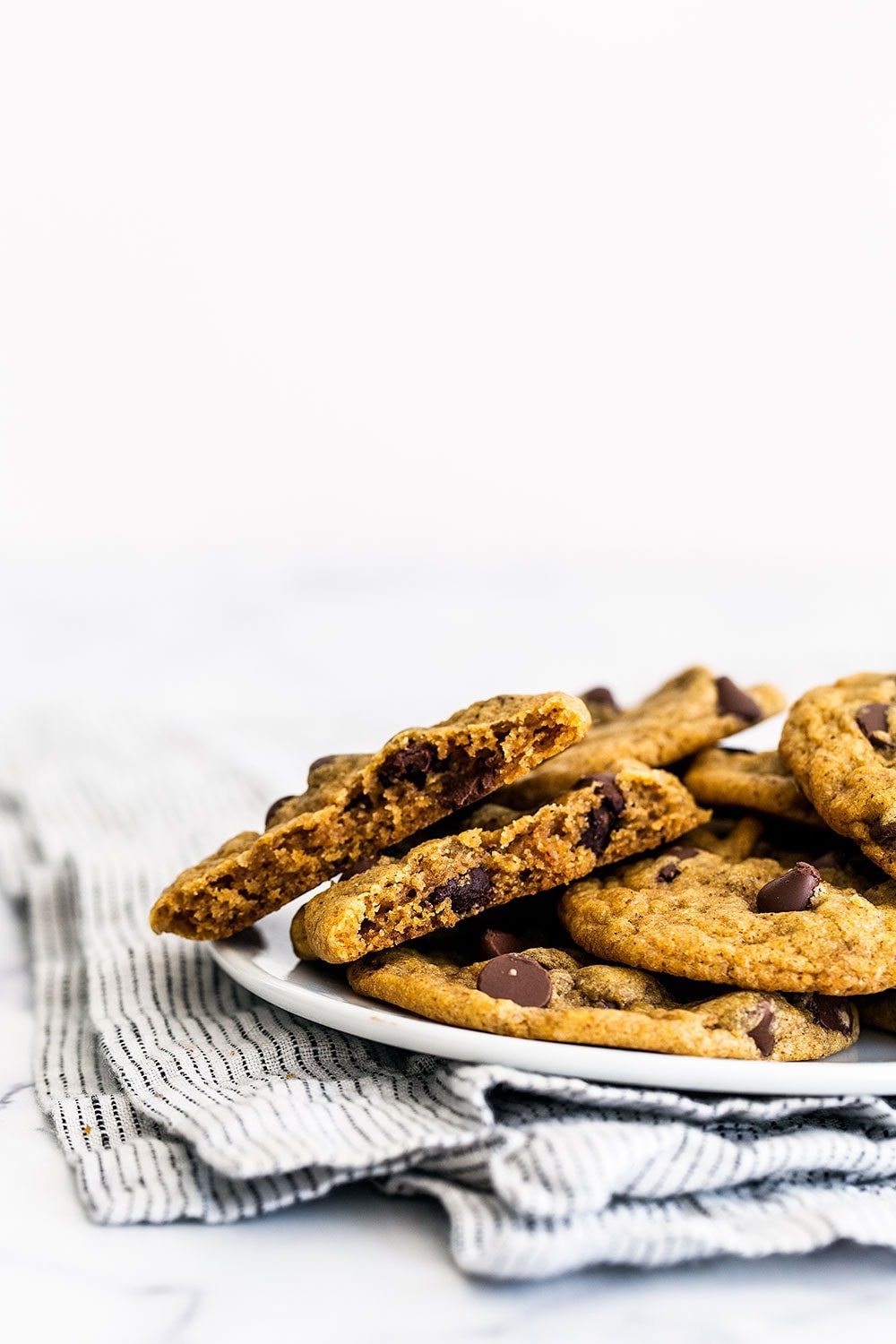 Brown Butter Pumpkin Chocolate Chip Cookies are CHEWY (not cakey) pumpkin spice cookies loaded with tons of caramelized butterscotch flavor and gooey chocolate chips. A fall favorite!