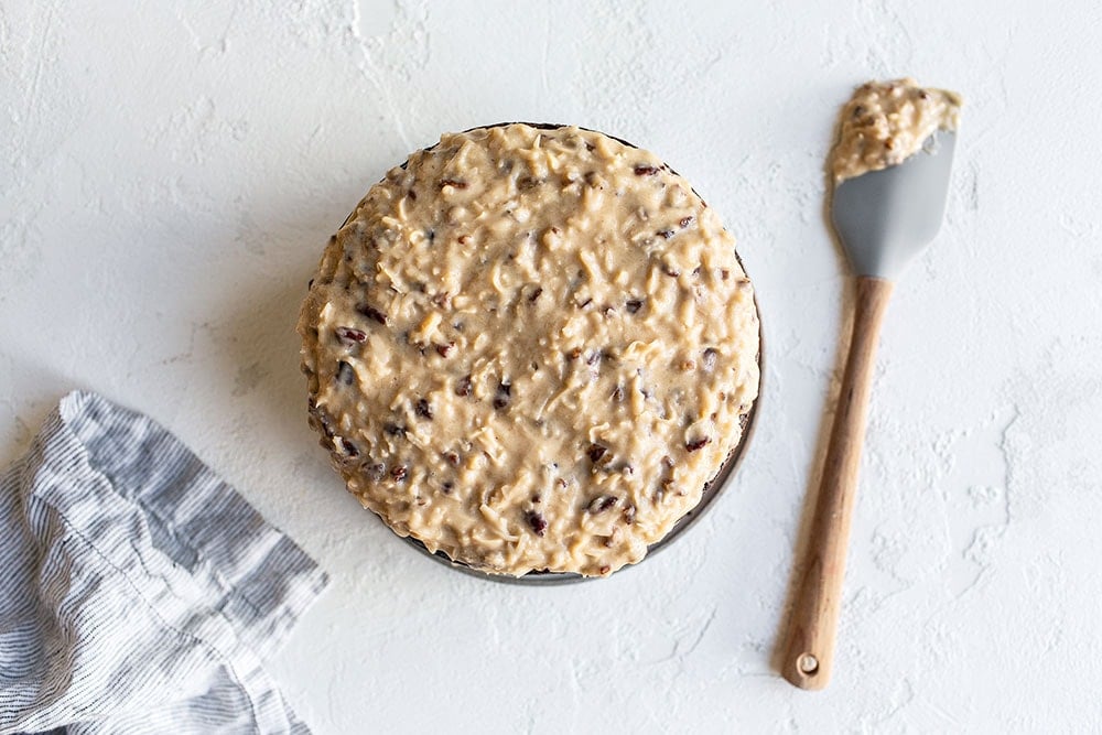 Spreading coconut-pecan icing on German Chocolate Cake