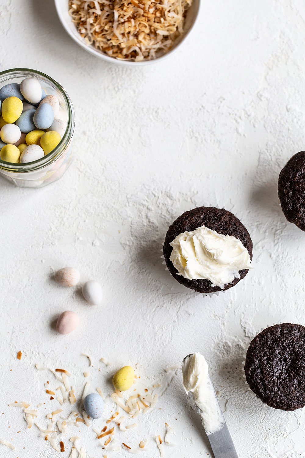Frosting chocolate cupcakes with coconut buttercream