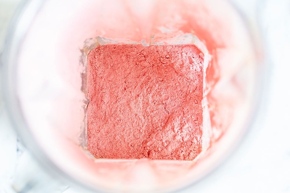 Freeze dried strawberries pulverized into a powder in the blender