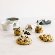 Cookie dough and baked cookies on a marble counter