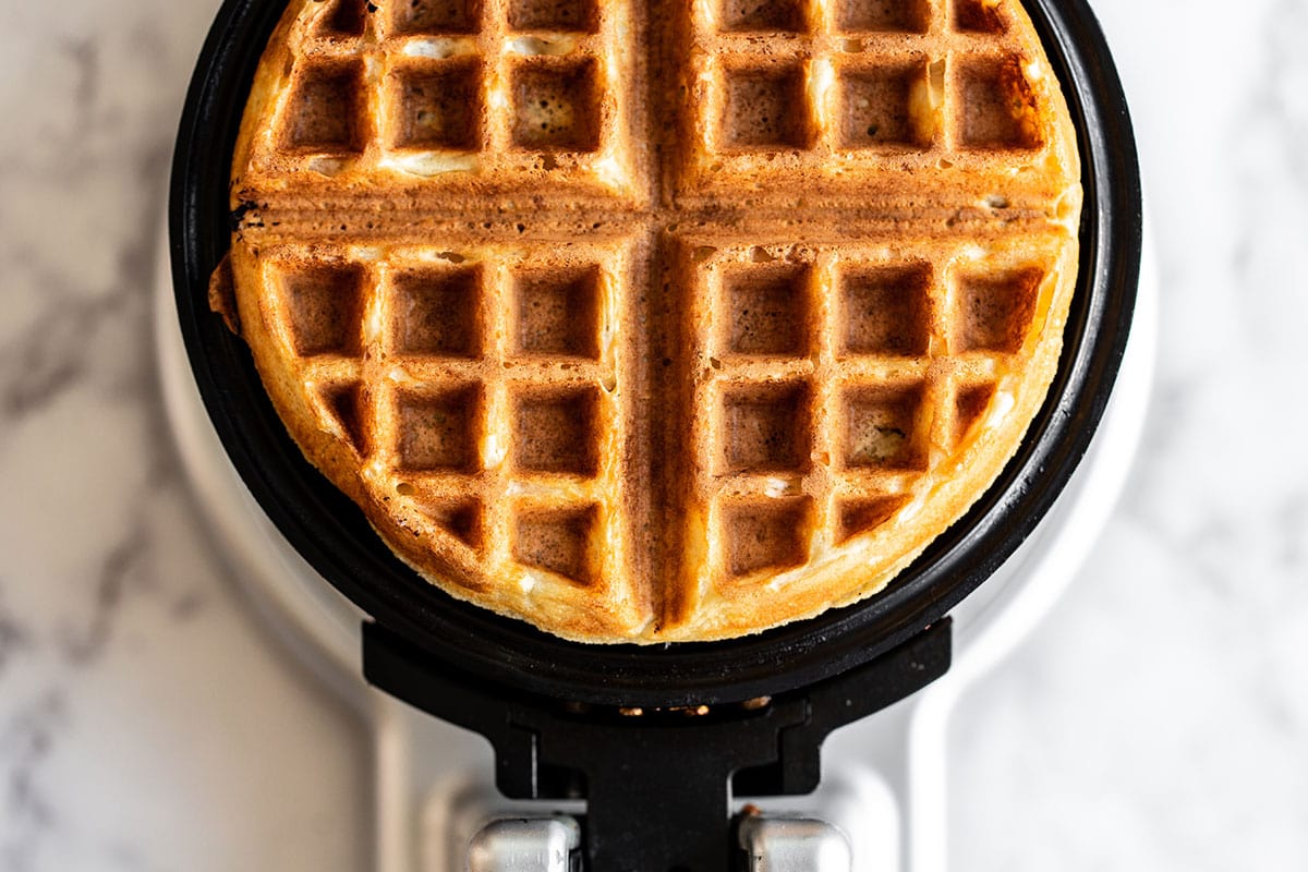 Belgian waffles cooking in waffle iron