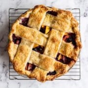 freshly baked blueberry peach pie cooling on rack